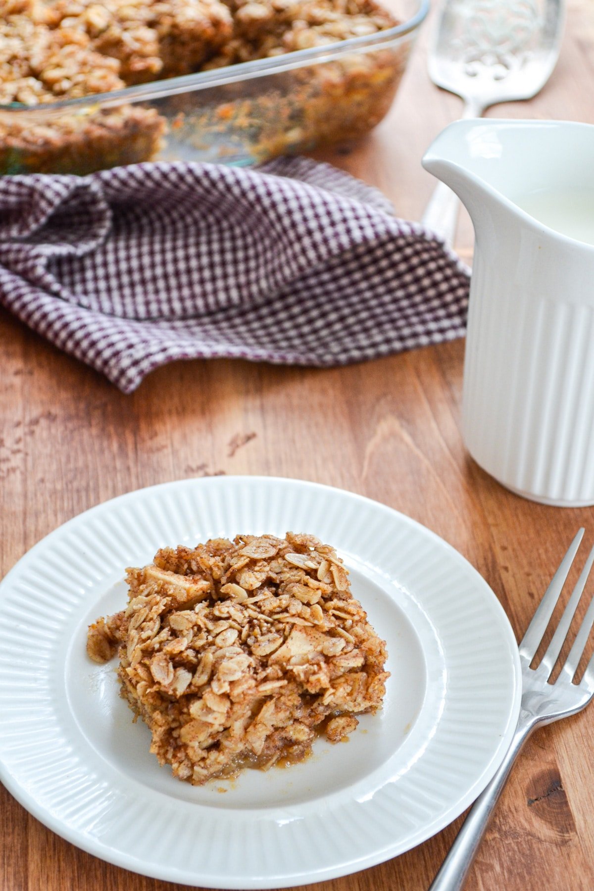 A square of baked oatmeal on a white plate.