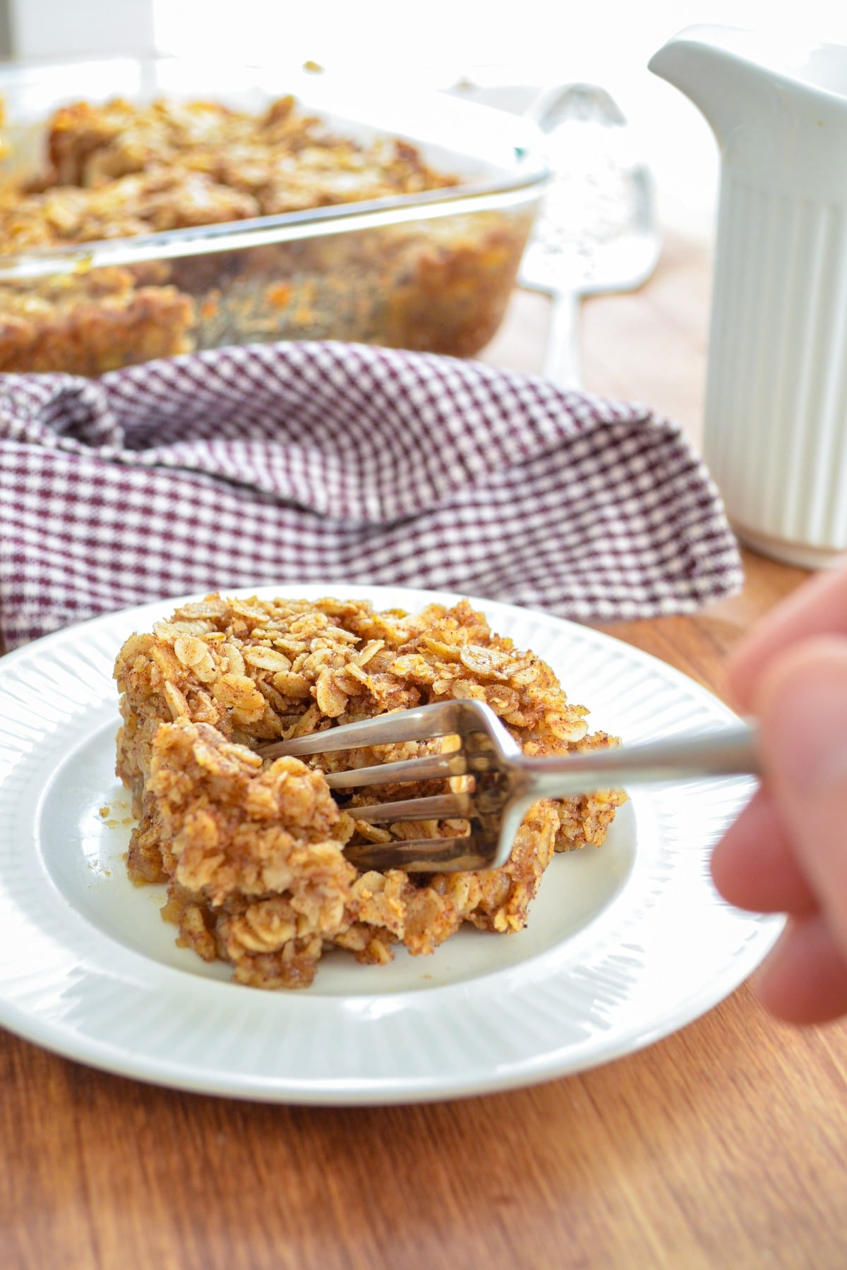 A fork taking a portion of apple cinnamon baked oatmeal.