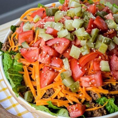 Forget Drive Thru! Try this yummy and healthy Deluxe Cheeseburger Salad! Romaine lettuce is topped with all your favorite Deluxe Cheeseburger toppings for an easy, quick, and healthy meal.