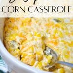 A dish of corn casserole with a spoon removing a portion.