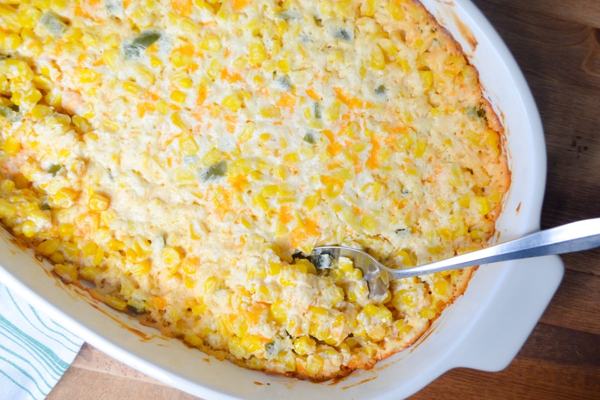 A casserole dish filled with a cream cheese and cheddar jalapeno corn casserole.