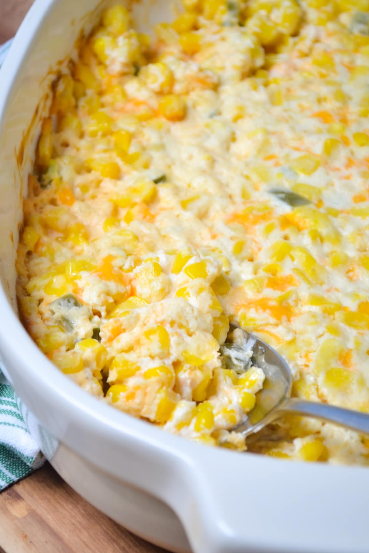 A spoon taking out a portion of corn casserole.