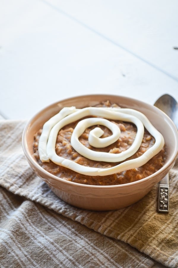 A comforting bowl of cinnamon roll oatmeal, complete with a cream cheese swirl.