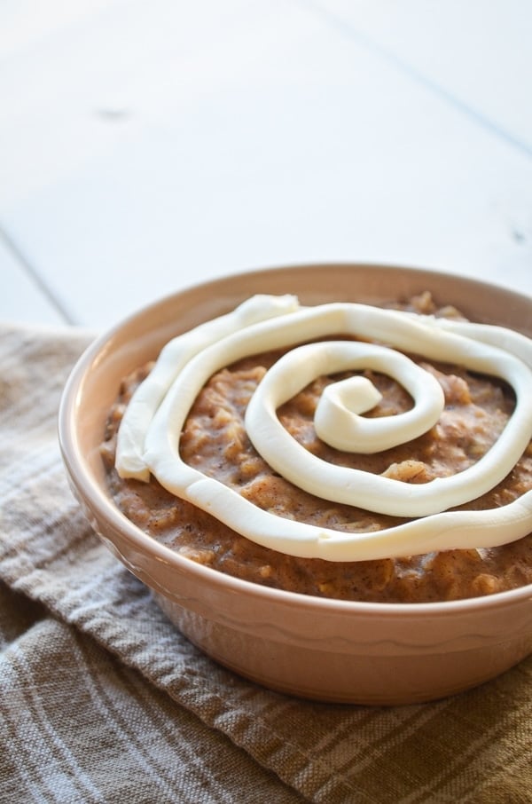 A warm bowl of cinnamon roll oatmeal, complete with a cream cheese swirl.