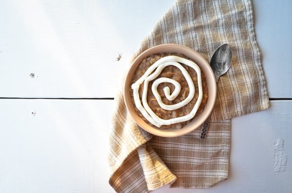 A warm, comforting bowl of cinnamon roll oatmeal, complete with a cream cheese swirl.