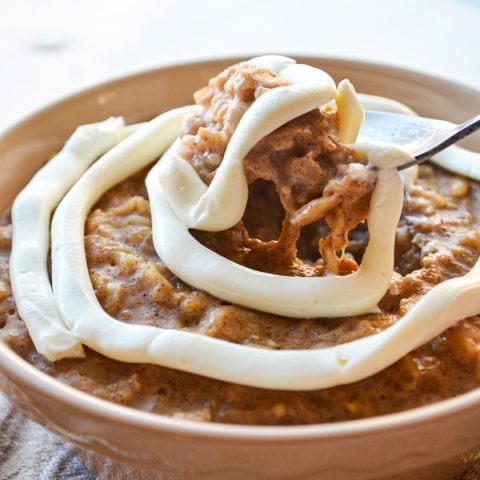 A spoon lifts a big spoonful of cinnamon roll oatmeal.
