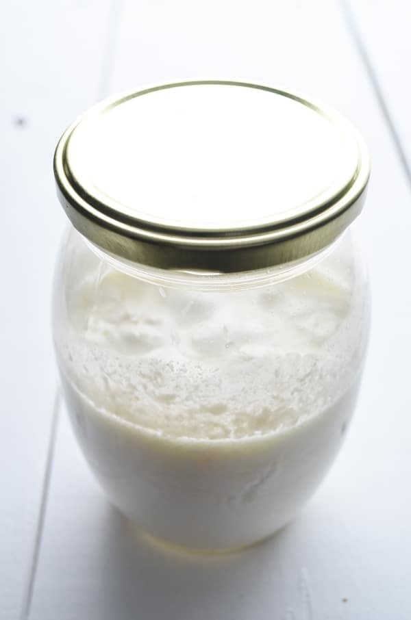 The milk kefir has fermented, and you can see pockets of whey forming in the jar.