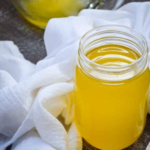 A jar of homemade instant pot ghee, surrounded by a white cloth towel.