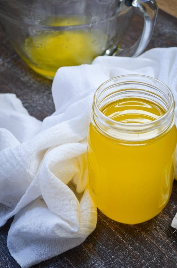 A jar of homemade instant pot ghee, surrounded by a white cloth towel.