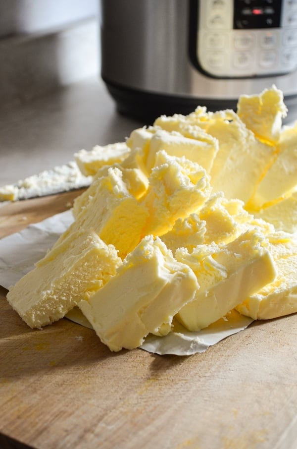 Cubed butter, with an Instant Pot in the background. Ready to make homemade ghee.