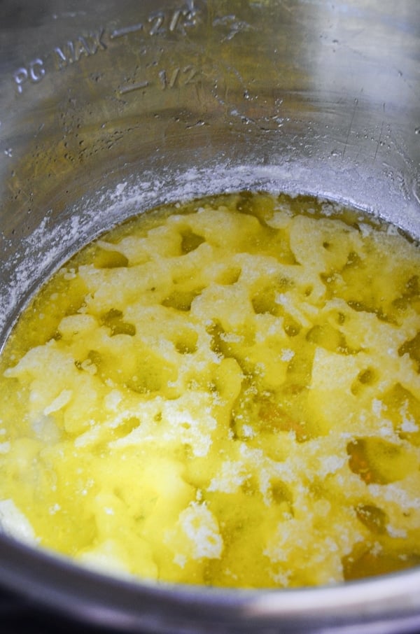 Milk solids continue to separate during the process of making ghee in the Instant Pot.