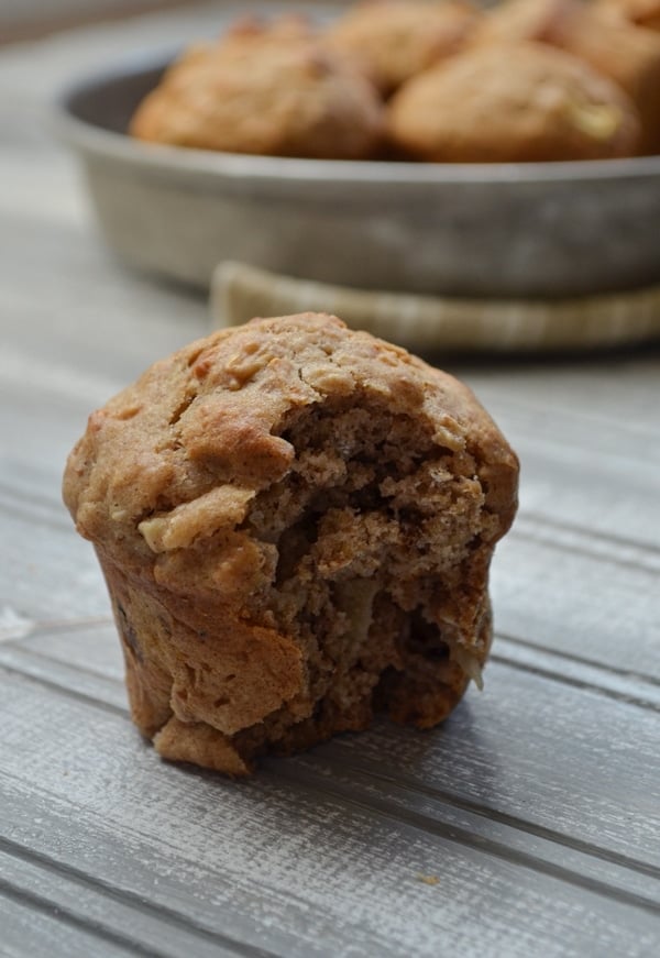 A sourdough muffin with a bite taken out of it.