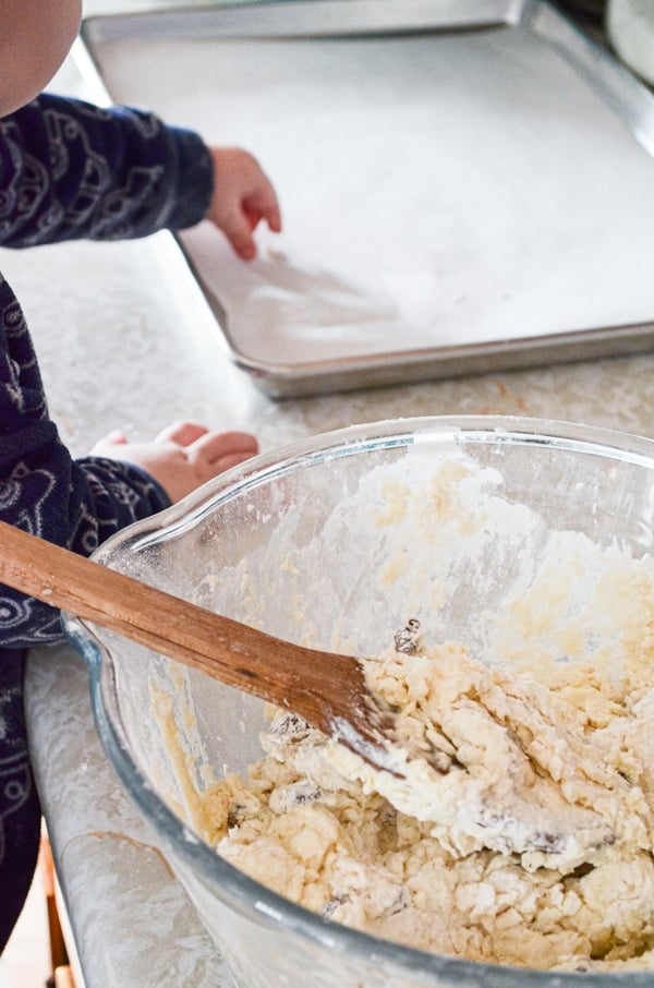 Stirring up the dough with a small toddler.