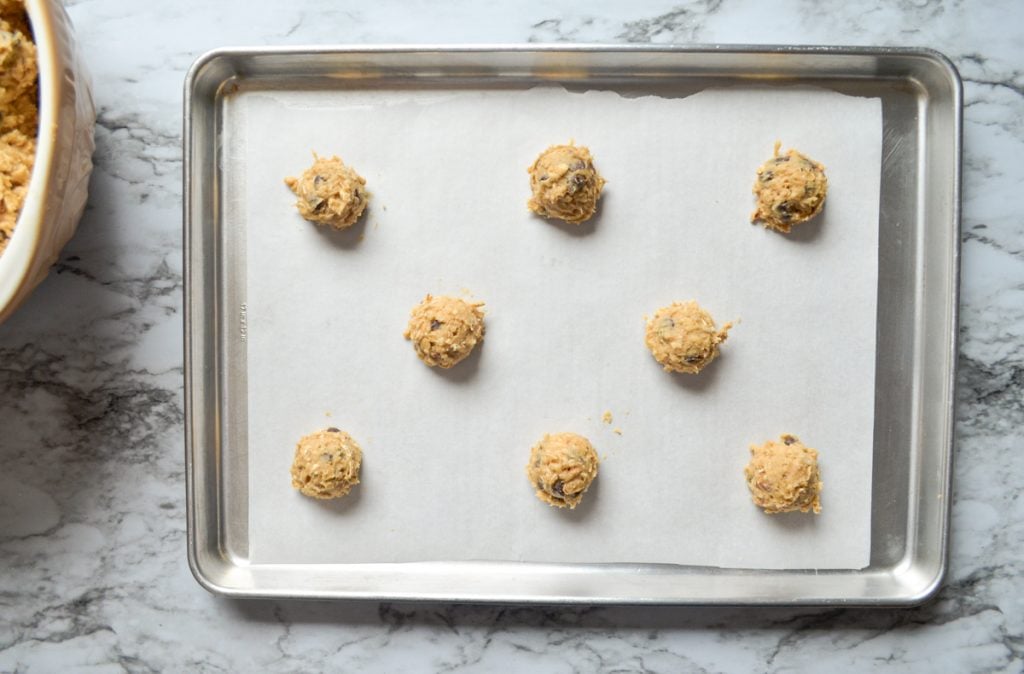 An overhead shot of cookies portioned onto a cookie sheet.