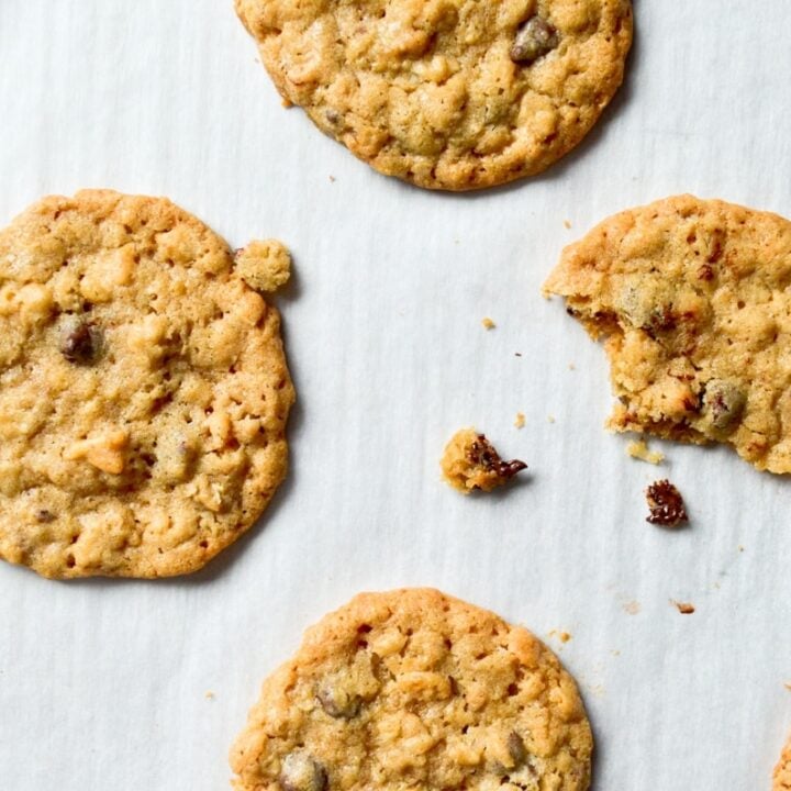 An overhead view of cookies, with a few crumbs of chocolate chip dough.