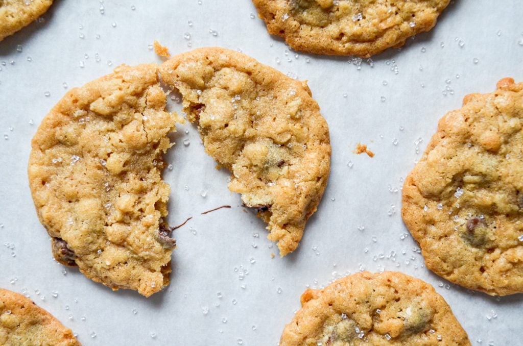 An overhead view of cookies on a parchment lined baking sheet.