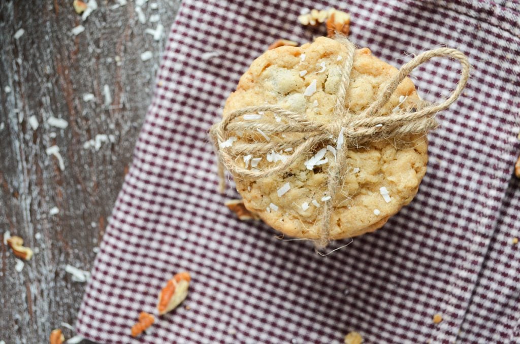 An overhead view of buffalo chip cookies. A stack of cookies tied with twine and laying on a cloth napkin.