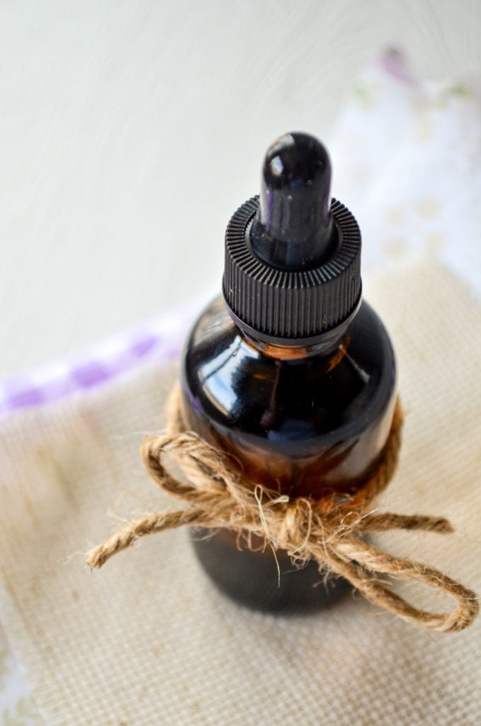 A bottle of DIY facial serum with twine tired around the bottle.