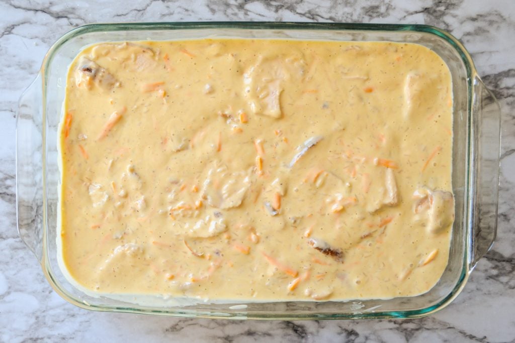 Chicken divine casserole spread into a baking dish.