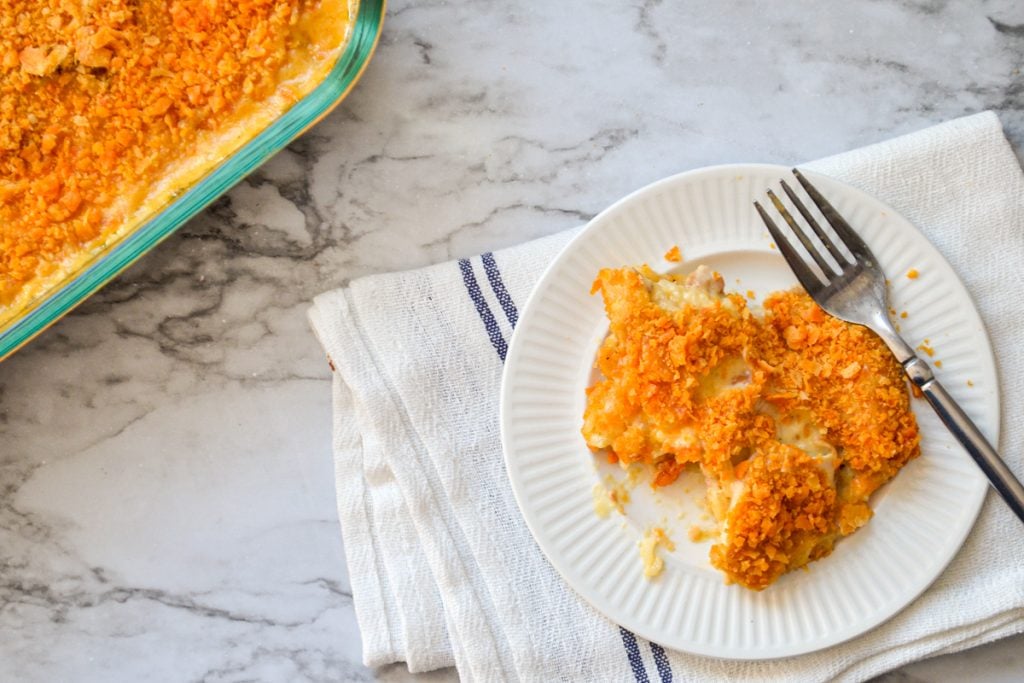 A chicken and rice casserole on a small white plate.