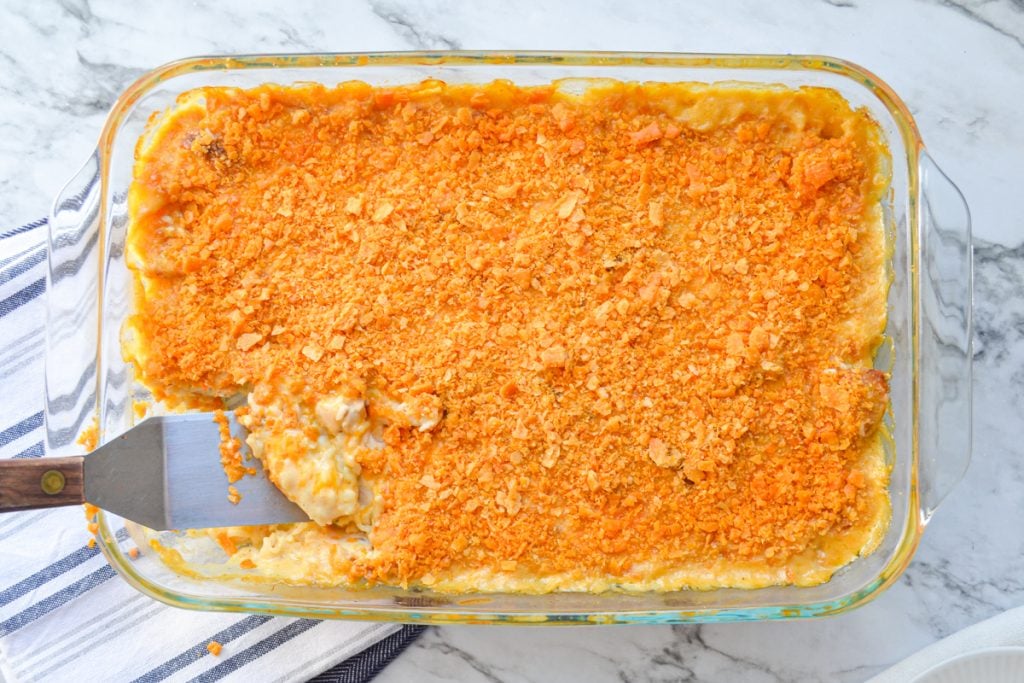An overhead shot of Chicken and Rice Casserole. A small serving spatula is in the bottom left of the baking dish.