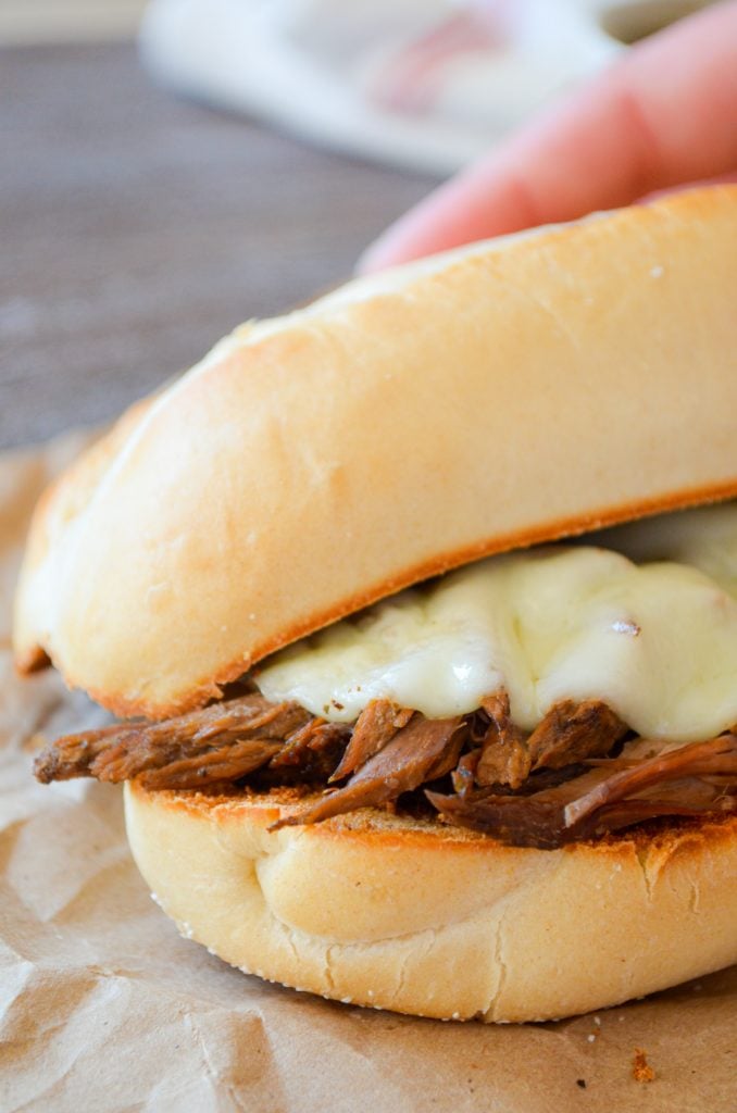 A french dip sandwich with melted provolone cheese.