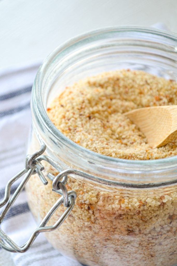 Sourdough breadcrumbs made from leftover sourdough bread. Crushed and in a small jar with a small wooden spoon inside.