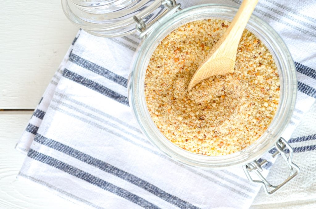 Sourdough breadcrumbs made from leftover sourdough bread. Crushed and in a small jar with a small wooden spoon inside.