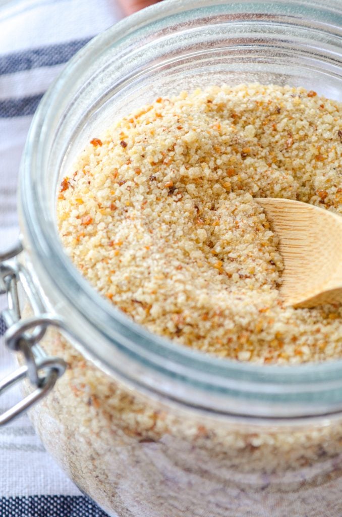 Sourdough breadcrumbs made from leftover sourdough bread. Crushed and in a small jar with a small wooden spoon inside.