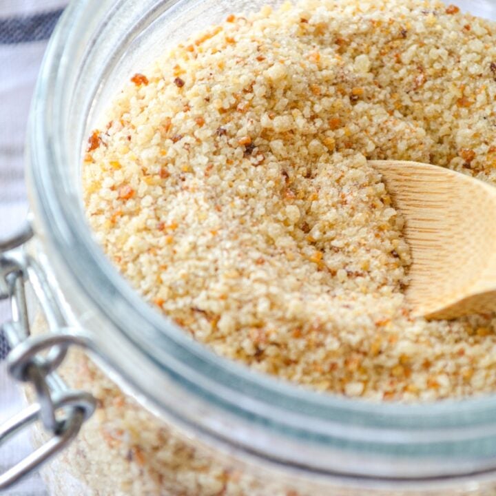 Sourdough breadcrumbs made from leftover sourdough bread. Crushed and in a small jar with a small wooden spoon inside.