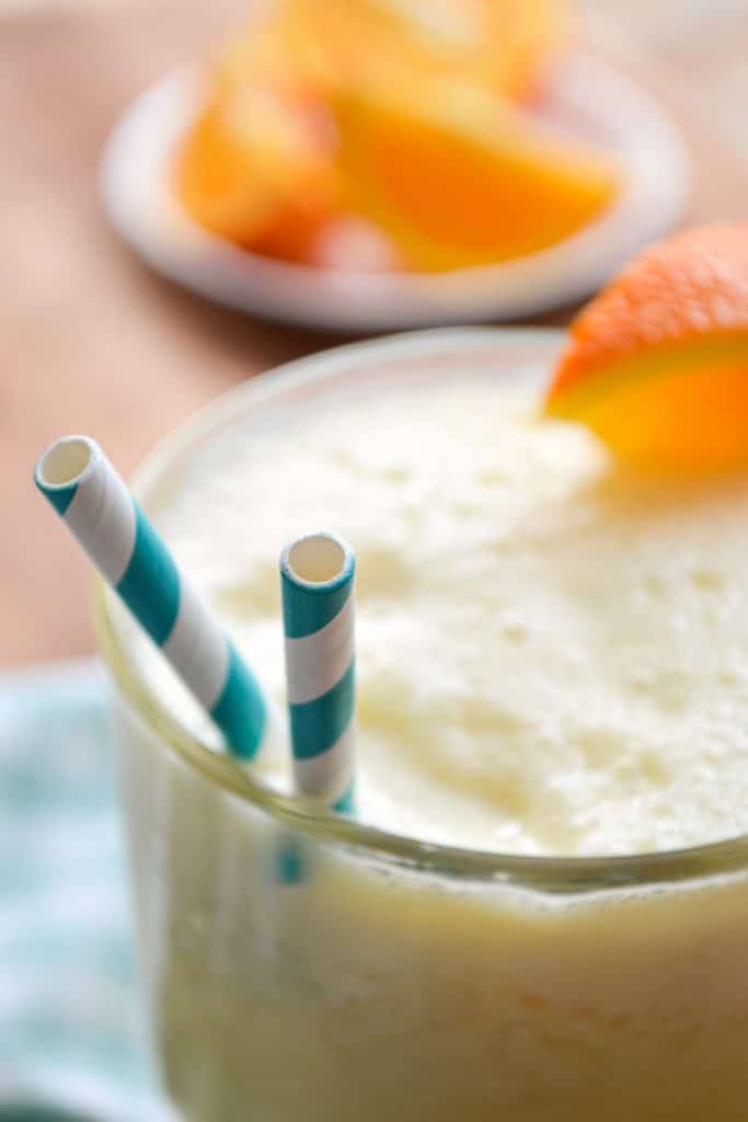 A closeup of copycat Orange Julius with two straws.