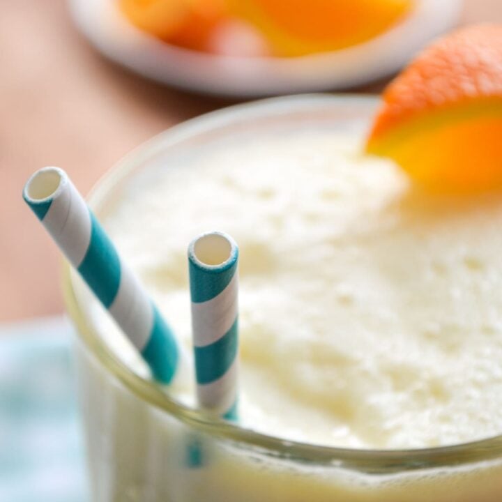 A closeup of copycat Orange Julius with two straws.