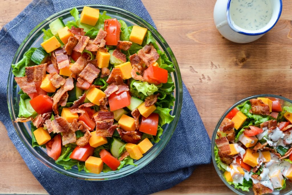 An overhead shot of a salad with dressing