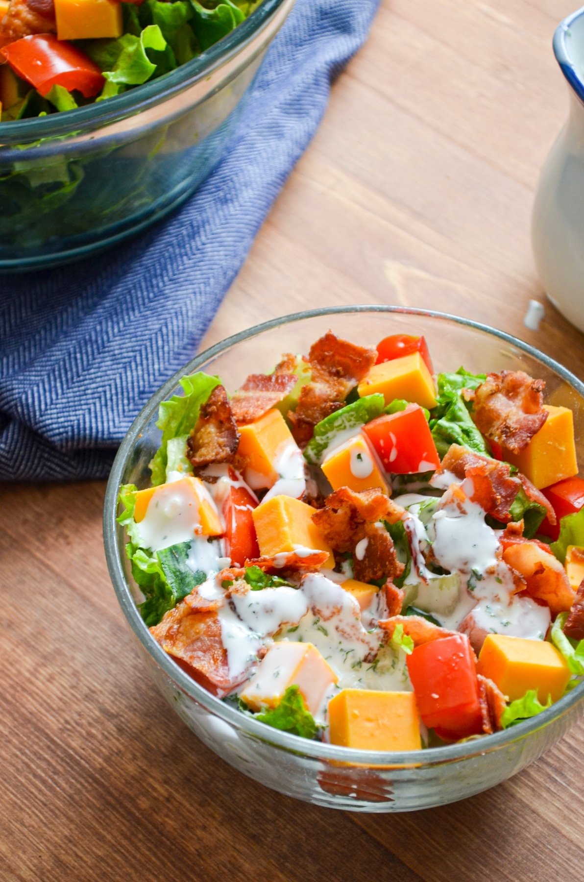 A bowl of salad, dressed with buttermilk ranch