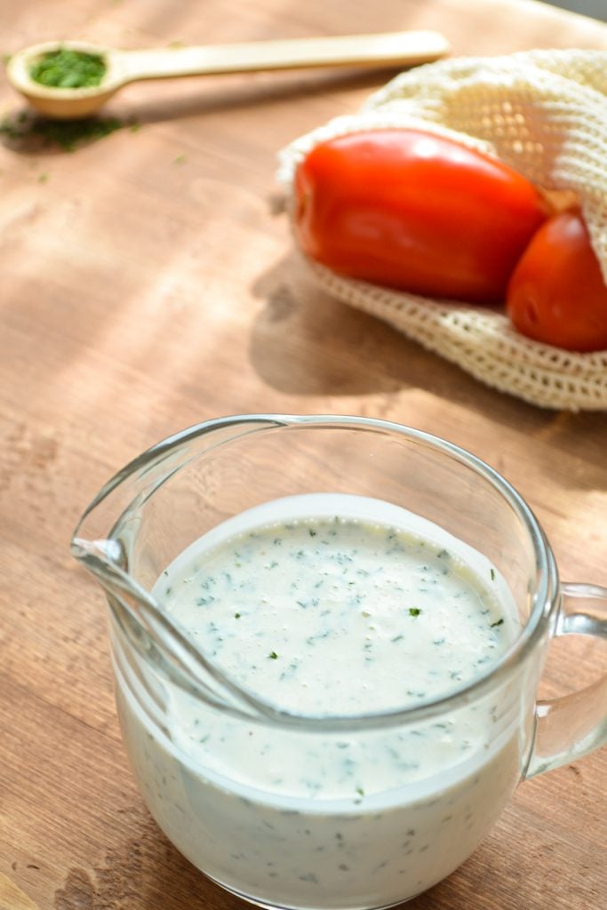 Homemade buttermilk ranch dressing in a small cruet.