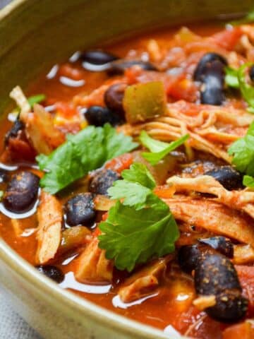 A bowl of chicken taco soup, garnished with cilantro.