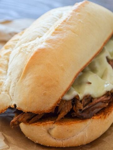 A french dip sandwich on butcher paper.