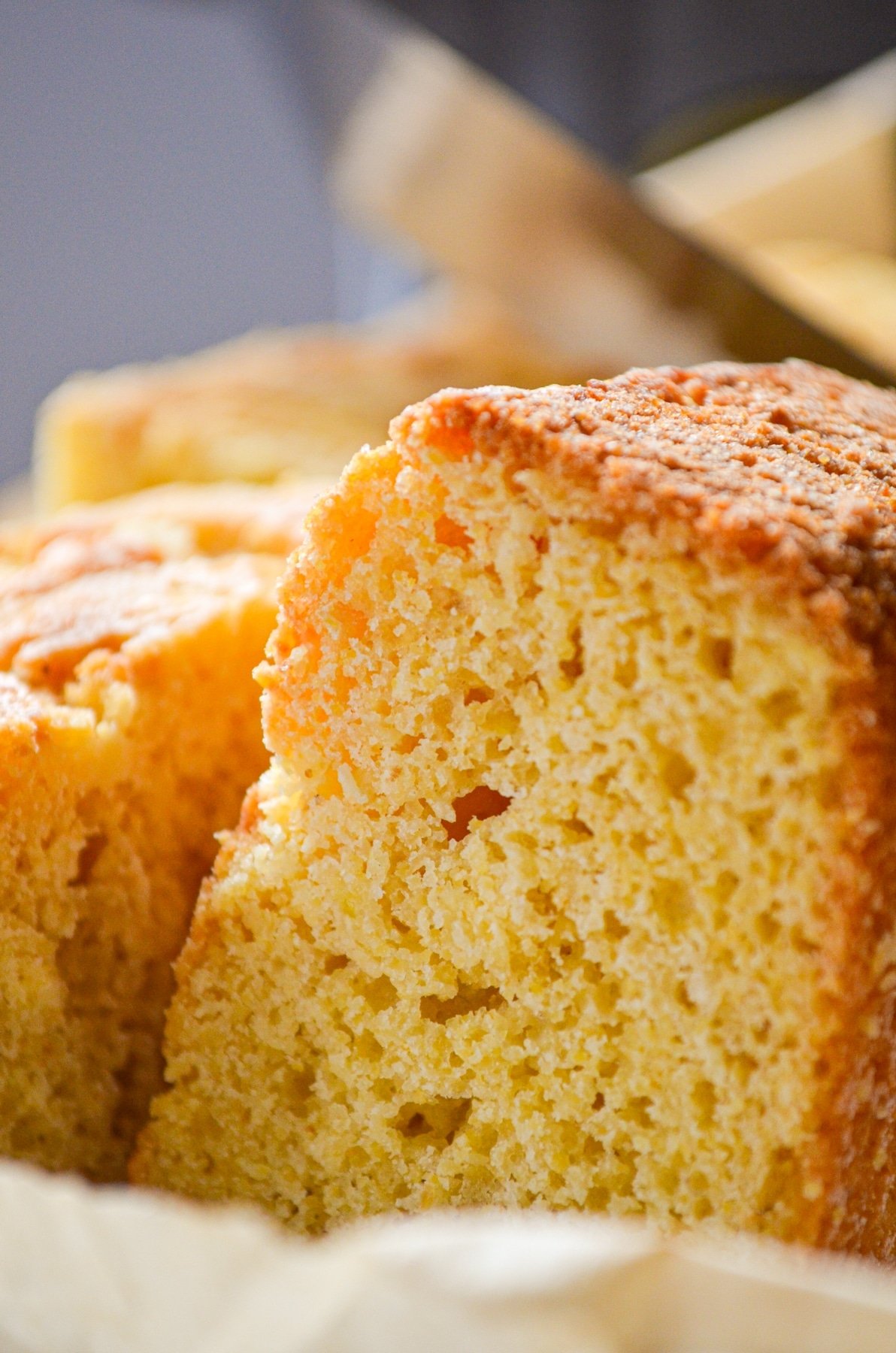 A close up of sourdough cornbread on a piece of parchment paper.