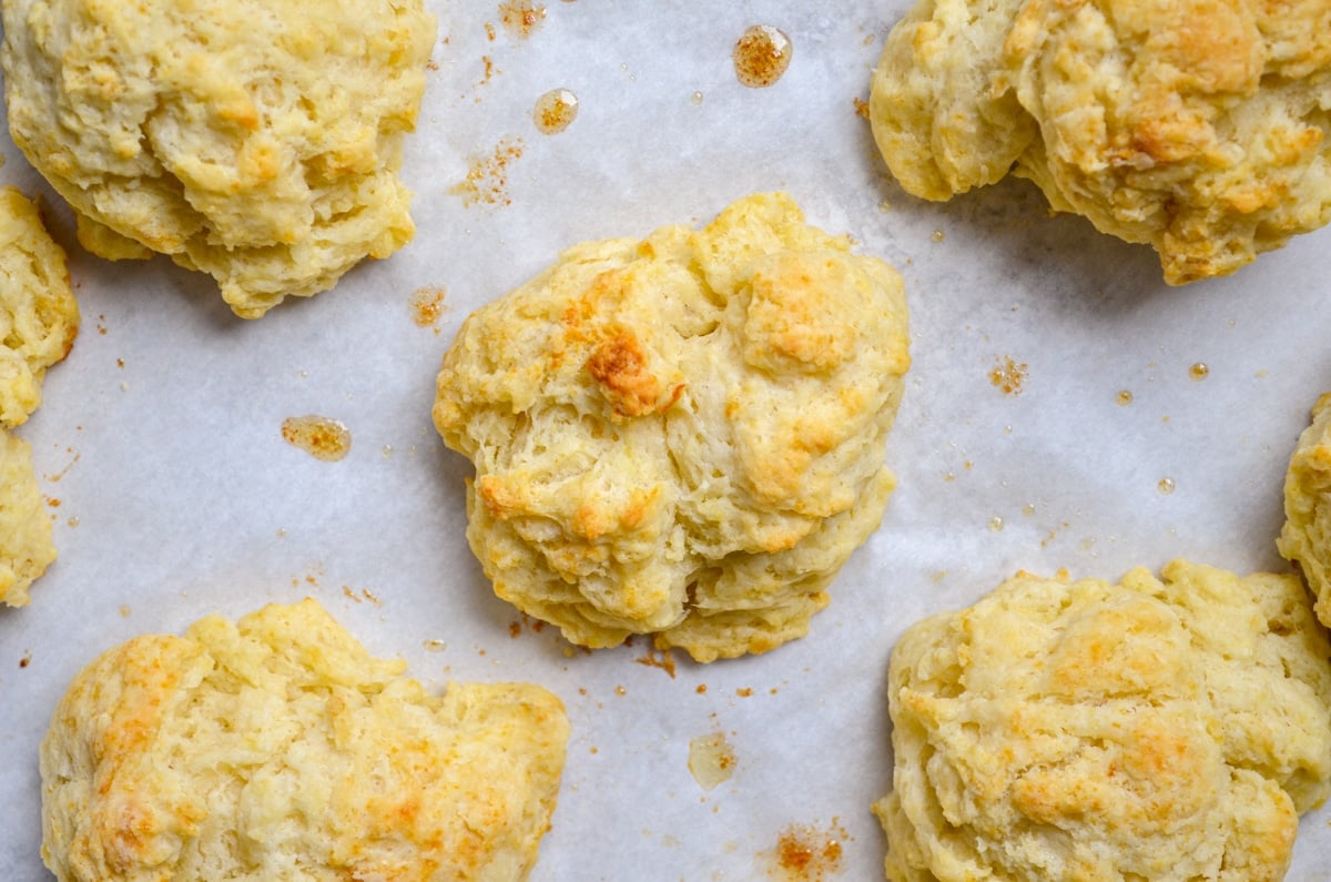 Sourdough drop biscuits on a baking sheet.