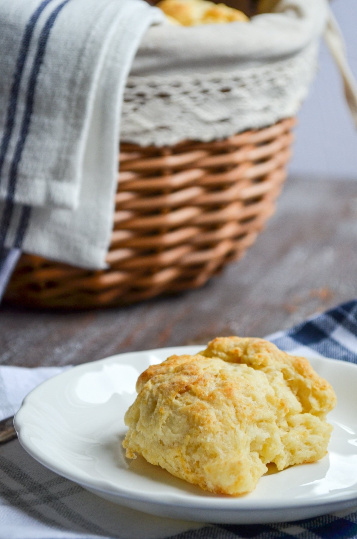 A sourdough discard biscuit on a white plate.