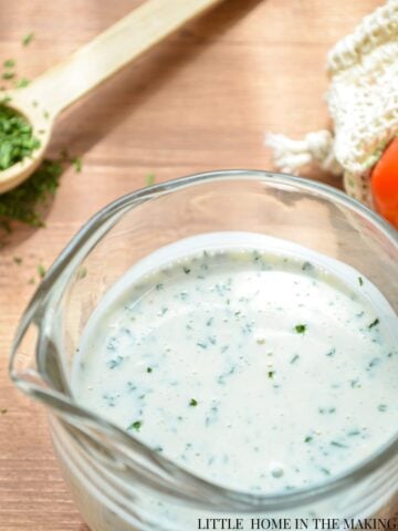 Homemade buttermilk ranch dressing in a small cruet.