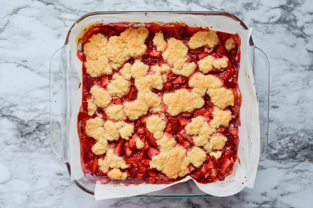 A baking dish of cooked strawberry oatmeal crumb bars.