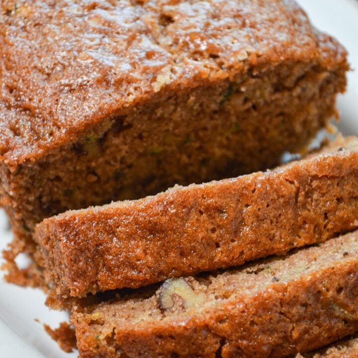 A loaf of sourdough zucchini bread, sliced into individual servings.