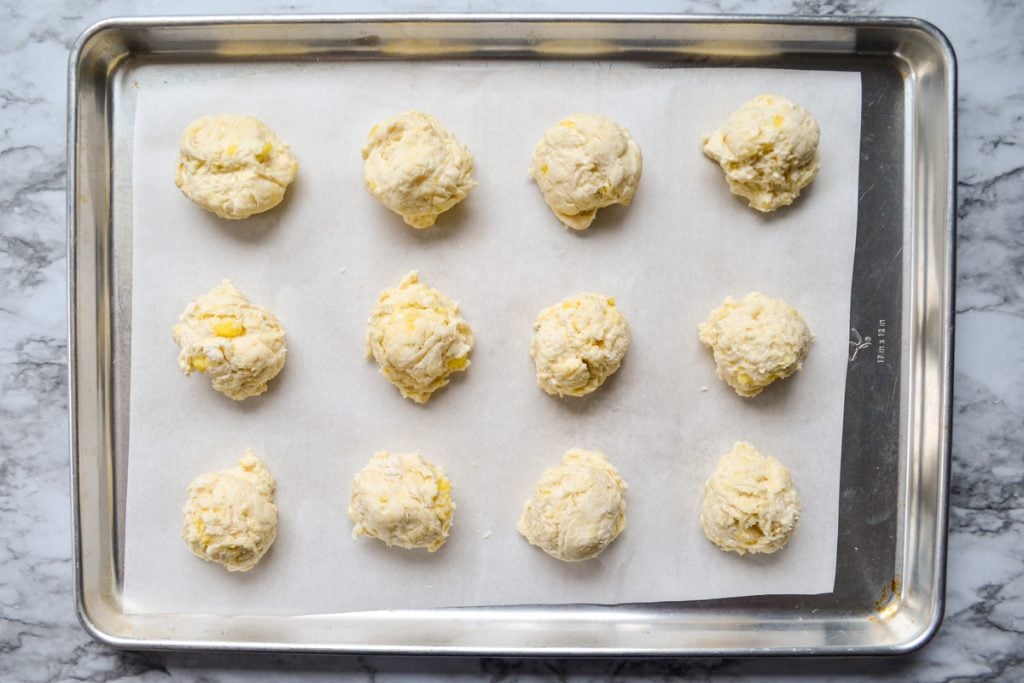 A baking sheet of drop biscuits. 