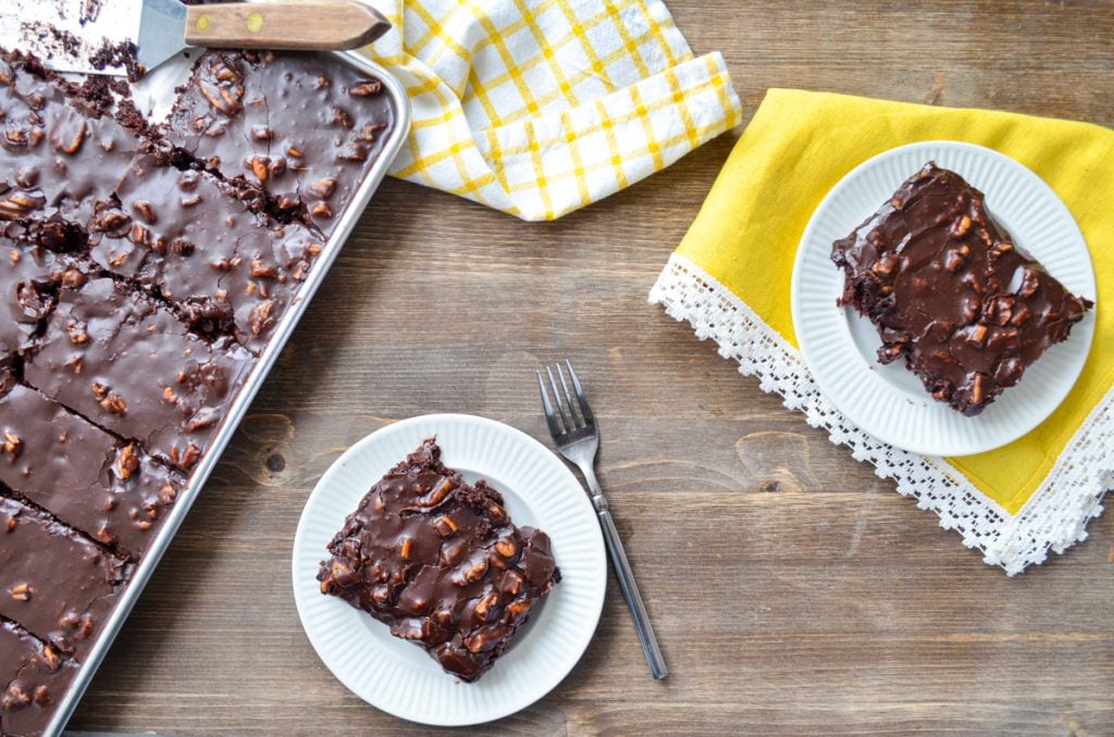 Two slices of sourdough texas sheet cake, and the sheet pan on the side.