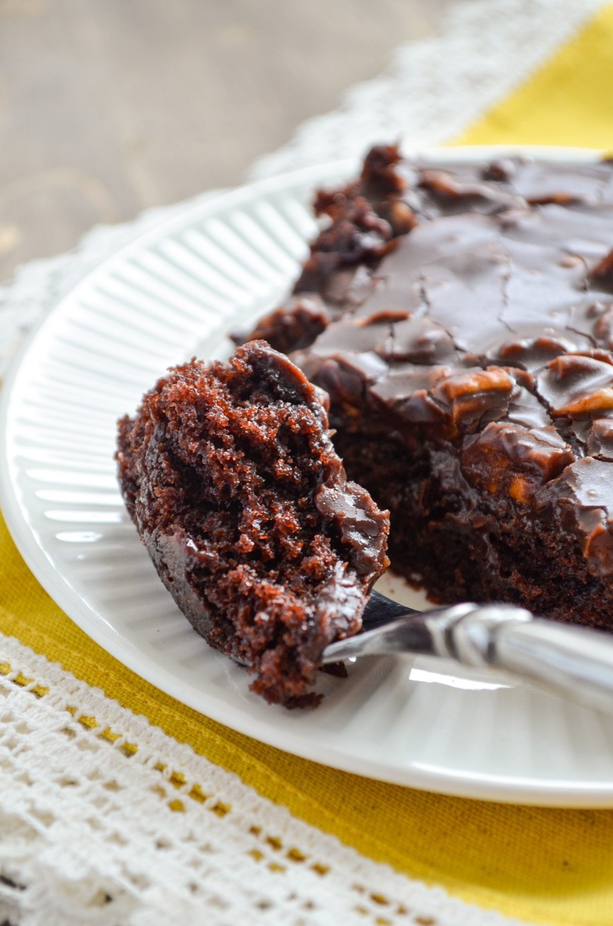 A fork, taking a portion of Sourdough Texas Sheet Cake.