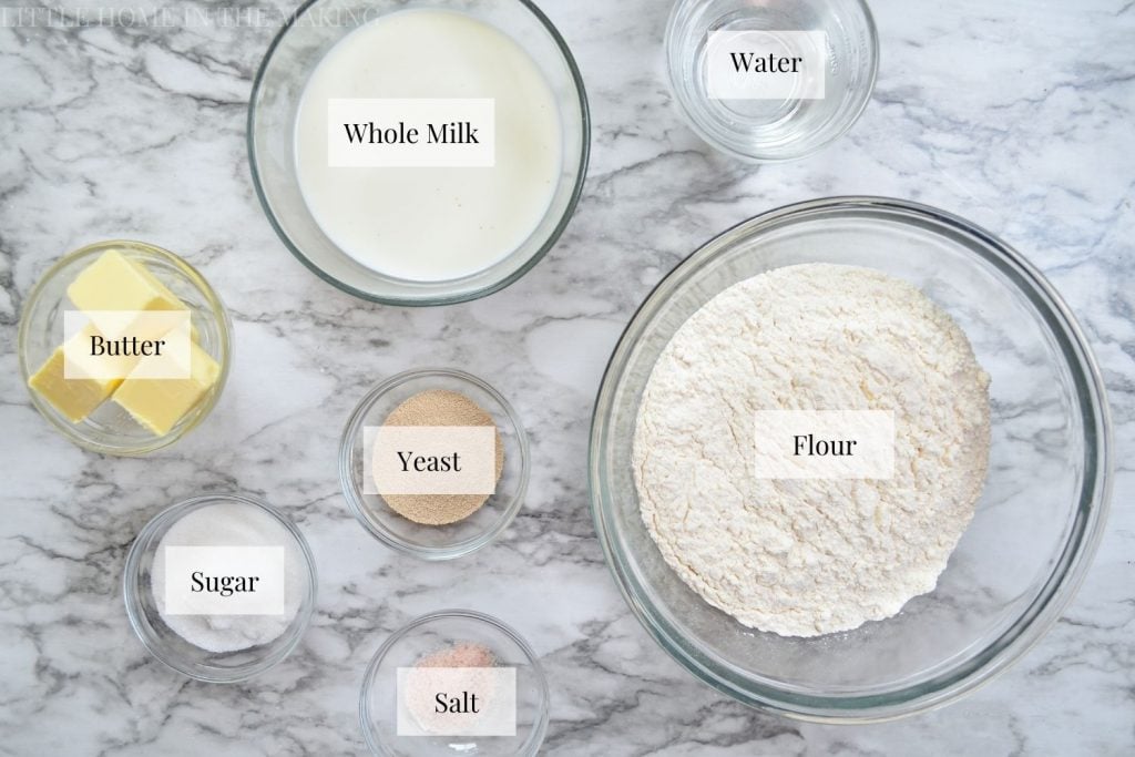 The ingredients needed to make snowflake rolls: flour, yeast, salt, sugar, water, milk, and butter.