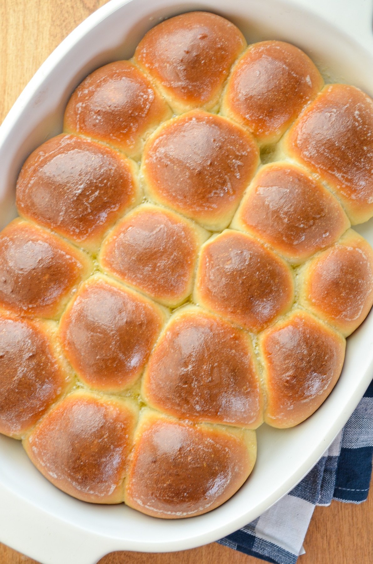 A baking dish filled with golden homemade rolls.