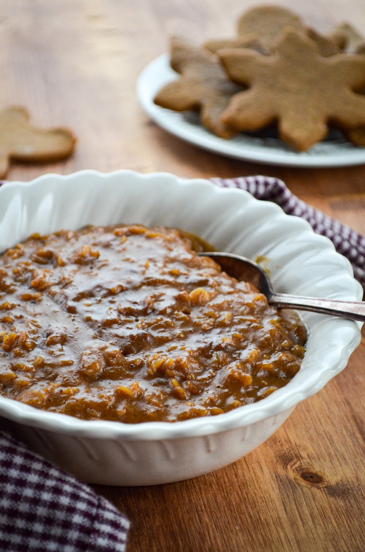 A bowl of homemade porridge, with cookies in the background.