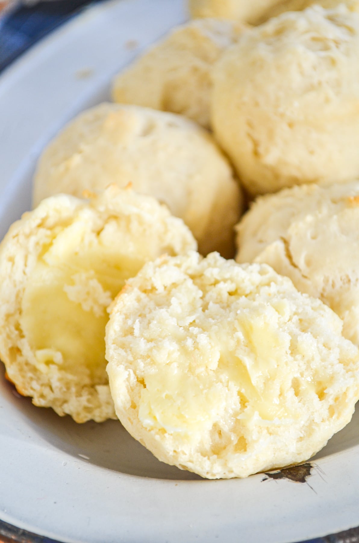 A plate of yeast free dinner rolls on a plate.